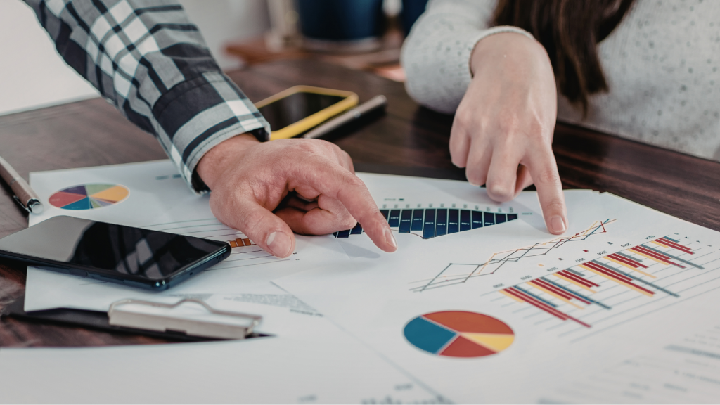 School leaders analysing printed data on an office desk.